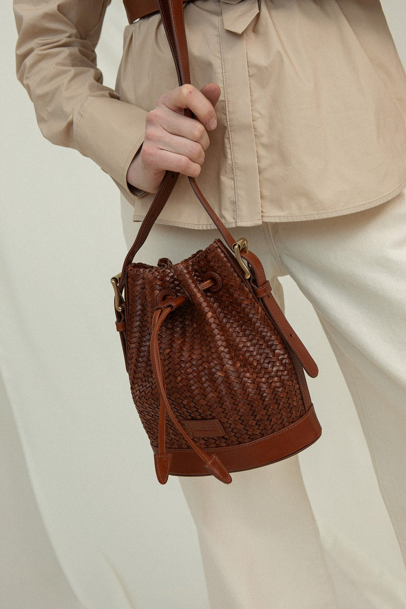 Cala Jade Gaya Mini Nutmeg Brown leather bucket bag  on model 2