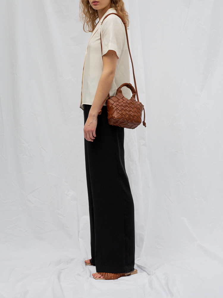 Cala Jade brown leather cross-body bag on model